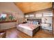 Bright and airy main bedroom with wood floors and mountain views at 5237 Bear Mountain Dr, Evergreen, CO 80439