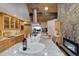 Open kitchen boasts granite island and wood cabinetry at 5237 Bear Mountain Dr, Evergreen, CO 80439