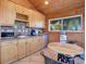 Cozy kitchenette with wood cabinets, microwave, and mini-fridge at 5237 Bear Mountain Dr, Evergreen, CO 80439