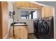 Convenient laundry room with washer, dryer, and sink at 5237 Bear Mountain Dr, Evergreen, CO 80439