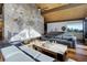 Spacious living room with stone fireplace and vaulted ceiling at 5237 Bear Mountain Dr, Evergreen, CO 80439
