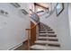 Elegant curved staircase with ornate railing and tiled steps at 5237 Bear Mountain Dr, Evergreen, CO 80439