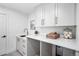 Bright laundry room with white cabinets and quartz countertops at 1152 S Adams St, Denver, CO 80210