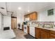 Basement kitchen with white appliances and wood cabinets at 12660 E Alaska Pl, Aurora, CO 80012