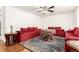 Living room with red couches, round table, and hardwood floors at 12660 E Alaska Pl, Aurora, CO 80012