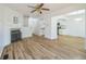 Spacious living room with hardwood floors, a fireplace, and access to the kitchen at 1745 W 102Nd Ave, Thornton, CO 80260