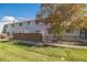 Gray siding townhouse exterior with brick wall and small fenced yard at 1745 W 102Nd Ave, Thornton, CO 80260