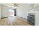 Living room with hardwood floors, fireplace, and sliding glass door to patio at 1745 W 102Nd Ave, Thornton, CO 80260