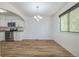 Kitchen and dining area with hardwood floors and modern appliances at 1745 W 102Nd Ave, Thornton, CO 80260
