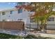 Exterior of townhome with brick wall and small fenced yard at 1745 W 102Nd Ave, Thornton, CO 80260