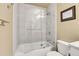 Bathroom with tub and shower, glass enclosure, and tile surround at 2901 N Wyandot St # 7, Denver, CO 80211