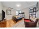 Spacious bedroom with hardwood floors and a brown leather chair at 4135 Perry St, Denver, CO 80212