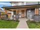 Front porch with rocking chairs and landscaping at 4135 Perry St, Denver, CO 80212