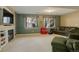 Finished basement featuring a fireplace and large windows offering natural light at 1065 Independence Dr, Larkspur, CO 80118