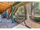 Basement stairs leading to a yard with wood pile and trees at 1065 Independence Dr, Larkspur, CO 80118