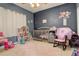 Charming bedroom with crib, rocking chair, and plenty of toy storage at 1065 Independence Dr, Larkspur, CO 80118