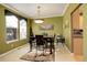Elegant dining room features a table with four chairs and large windows at 1065 Independence Dr, Larkspur, CO 80118