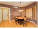 Charming dining area with a round table and chairs, wood floors, and window shutters at 1065 Independence Dr, Larkspur, CO 80118