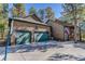 Three car garage with green doors at 1065 Independence Dr, Larkspur, CO 80118