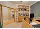 Home office with built-in shelving and French doors at 1065 Independence Dr, Larkspur, CO 80118
