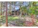 Two-story home nestled in a wooded area with green lawn at 1065 Independence Dr, Larkspur, CO 80118