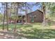 Two-story home surrounded by trees in a wooded setting at 1065 Independence Dr, Larkspur, CO 80118