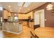 Well-equipped kitchen features an island, granite countertops, and warm wood cabinets at 1065 Independence Dr, Larkspur, CO 80118