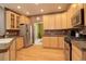 Modern kitchen with light wood cabinets, granite countertops, and stainless steel appliances at 1065 Independence Dr, Larkspur, CO 80118