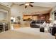 Spacious living room features an open floor plan, hardwood floors, and a view into the kitchen at 1065 Independence Dr, Larkspur, CO 80118