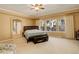 Large main bedroom with a king-size bed, ample natural light, and a ceiling fan at 1065 Independence Dr, Larkspur, CO 80118