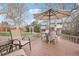 Backyard deck with table and chairs, surrounded by trees at 5948 Routt St, Arvada, CO 80004