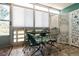 Sunroom/patio with tiled flooring, metal table and chairs, and decorative screen at 350 S Clinton St # 4A, Denver, CO 80247