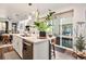 Modern kitchen island with white cabinetry, quartz countertops, and stainless steel appliances at 5316 Spalding Pl, Frederick, CO 80504