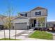 Two-story house with gray siding, stone accents, and a two-car garage at 3453 N Irvington St, Aurora, CO 80019