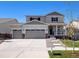 Two-story house with gray siding, stone accents, and a two-car garage at 3453 N Irvington St, Aurora, CO 80019
