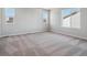 Spacious bedroom with plush carpeting and large windows offering ample natural light at 3453 N Irvington St, Aurora, CO 80019