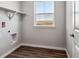 Laundry room with built-in shelving and window at 3453 N Irvington St, Aurora, CO 80019