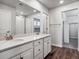 Main bathroom with dual vanity sinks, white cabinets, and a walk-in closet at 3453 N Irvington St, Aurora, CO 80019