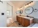 Double vanity bathroom with modern fixtures and tile flooring at 6327 S Miller Ct, Littleton, CO 80127