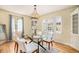 Bright dining room with built-in cabinetry, hardwood floors, and glass table at 2645 Ash St, Denver, CO 80207