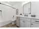 Modern bathroom with grey vanity, white subway tile, and a bathtub at 959 Eldorado Ln, Louisville, CO 80027