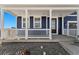 Charming front porch with white columns and railing at 959 Eldorado Ln, Louisville, CO 80027