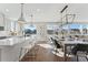 Open concept kitchen and dining area with stainless steel appliances and hardwood floors at 959 Eldorado Ln, Louisville, CO 80027