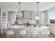 Modern kitchen with white cabinets, large island, and pendant lighting at 959 Eldorado Ln, Louisville, CO 80027