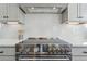 Stainless steel gas cooktop with modern range hood above at 959 Eldorado Ln, Louisville, CO 80027