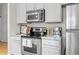 Modern kitchen with stainless steel appliances and white cabinets at 7240 W Custer Ave # 119, Lakewood, CO 80226