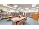 Community library with bookshelves and seating area at 775 S Alton Way # 3D, Denver, CO 80247