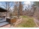 Landscaped backyard with patio, mature trees, and stone pathway at 5262 E Maplewood Pl, Centennial, CO 80121