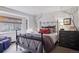 Cozy bedroom with a metal bed frame and window seat at 5262 E Maplewood Pl, Centennial, CO 80121