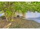 Front yard of a light beige townhouse with a large tree at 492 S Kalispell Way # C, Aurora, CO 80017